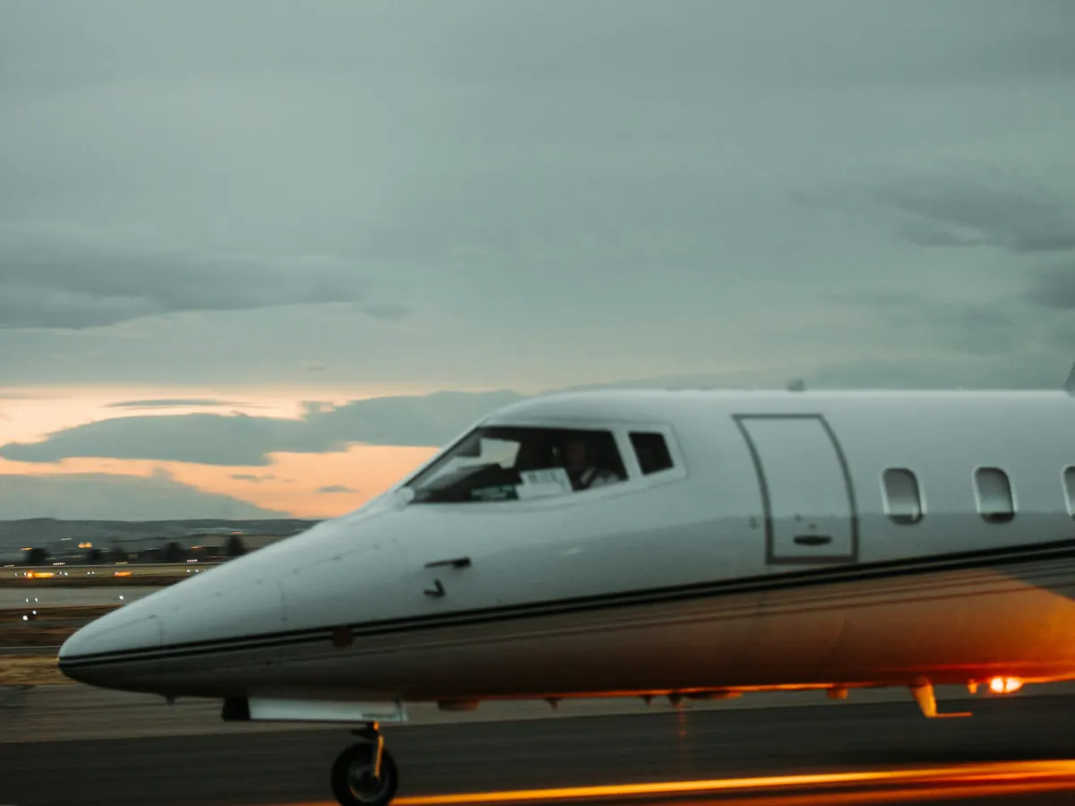 A light business jet on the ramp at dusk
