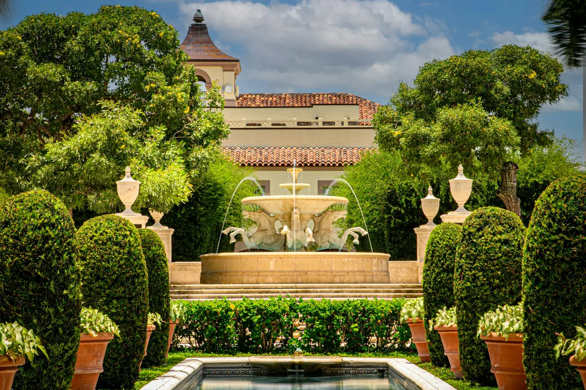 A fountain and palms in a formal Palm Beach garden